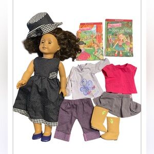 American girl doll and additional outfits, boots & books. Making a bundle!